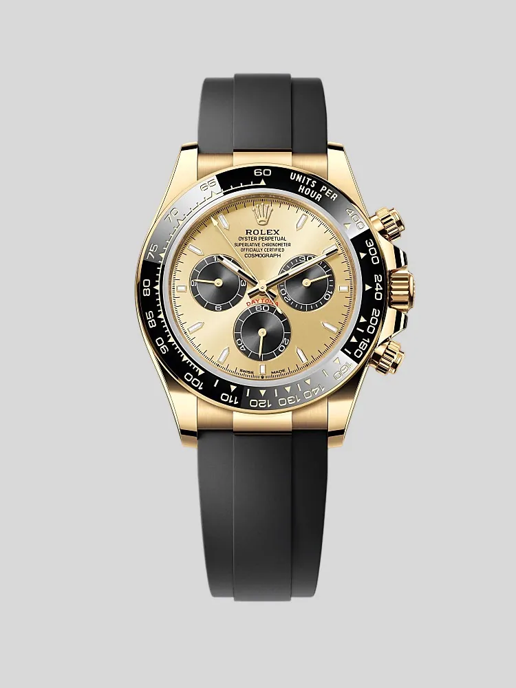 Rolex Daytona chronograph watch with a champagne dial, black ceramic bezel, and black rubber strap.