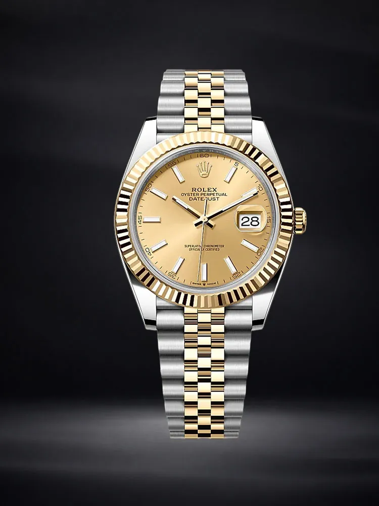Rolex Datejust watch with a champagne dial and two-tone bracelet on a deep navy background.