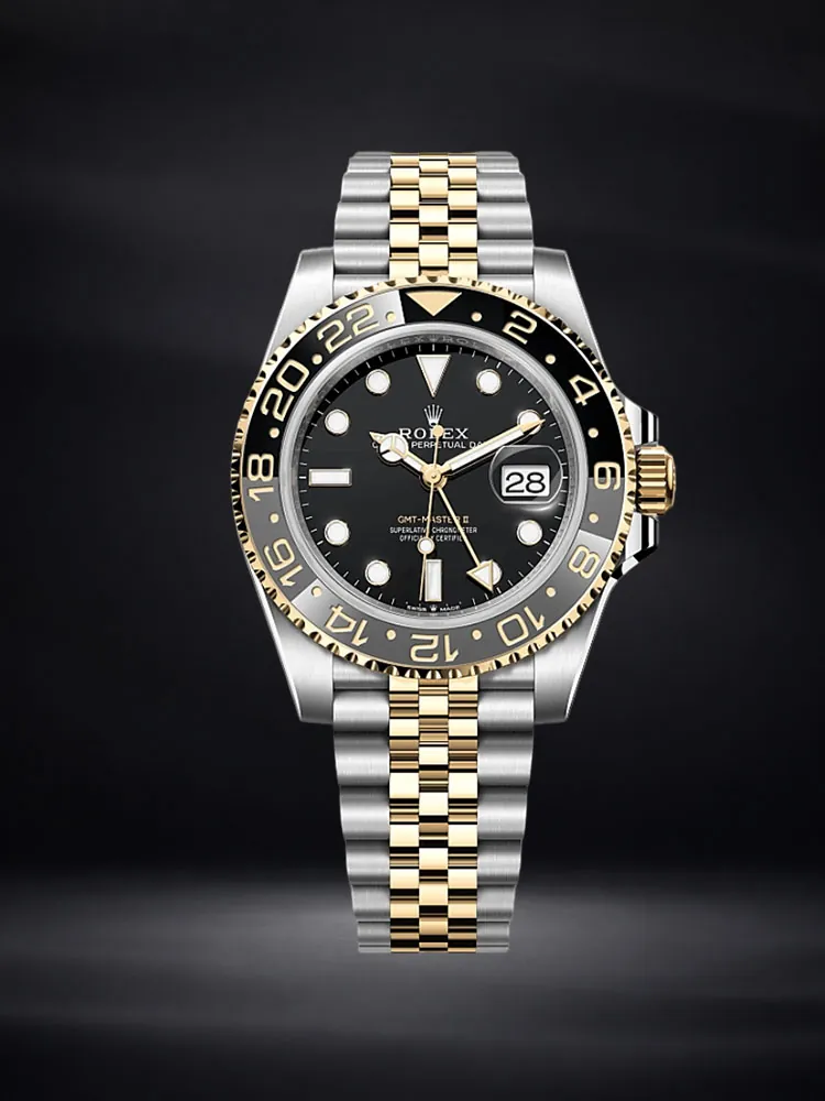 Rolex GMT-Master II watch with a black dial and two-tone jubilee bracelet on a deep navy background.