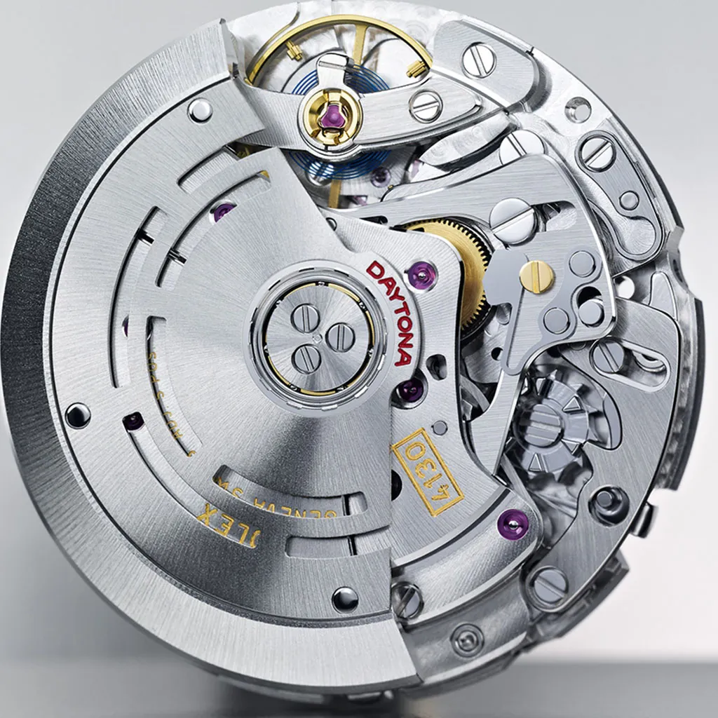 Close-up of a silver automatic watch movement with gears, rotor, and jewel bearings.