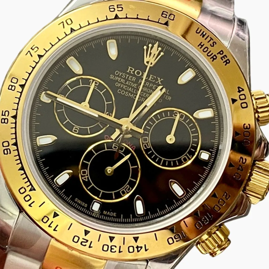 Rolex Daytona-style chronograph watch with black dial, gold tachymeter bezel, three subdials, luminous hour markers, and two-tone bracelet