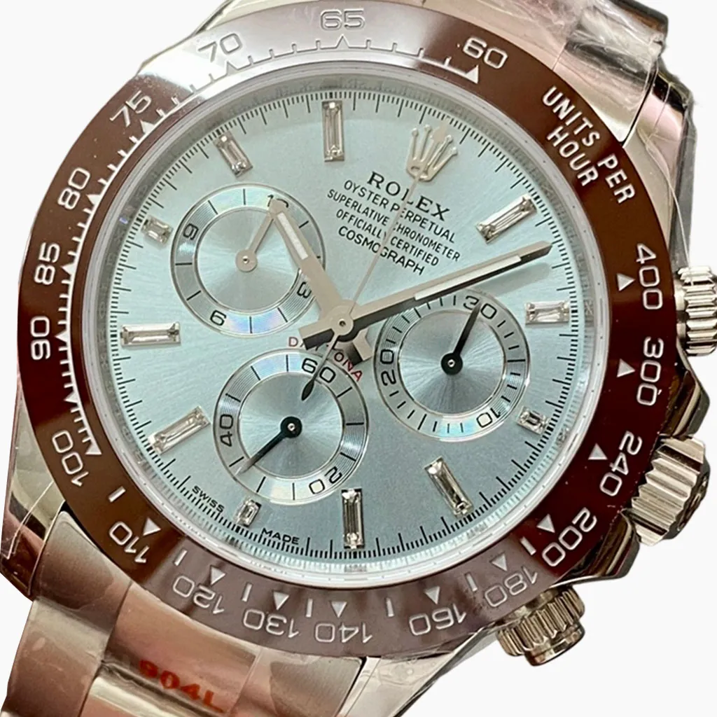 Close-up of a Rolex Daytona-style chronograph watch with an ice blue dial, brown tachymeter bezel, diamond hour markers, and polished metal case