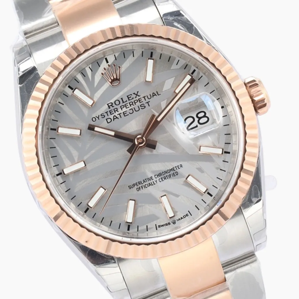 Rolex Datejust 36 126231 silver palm motif dial watch with Everose gold fluted bezel, Cyclops date window, and two-tone Oyster bracelet.