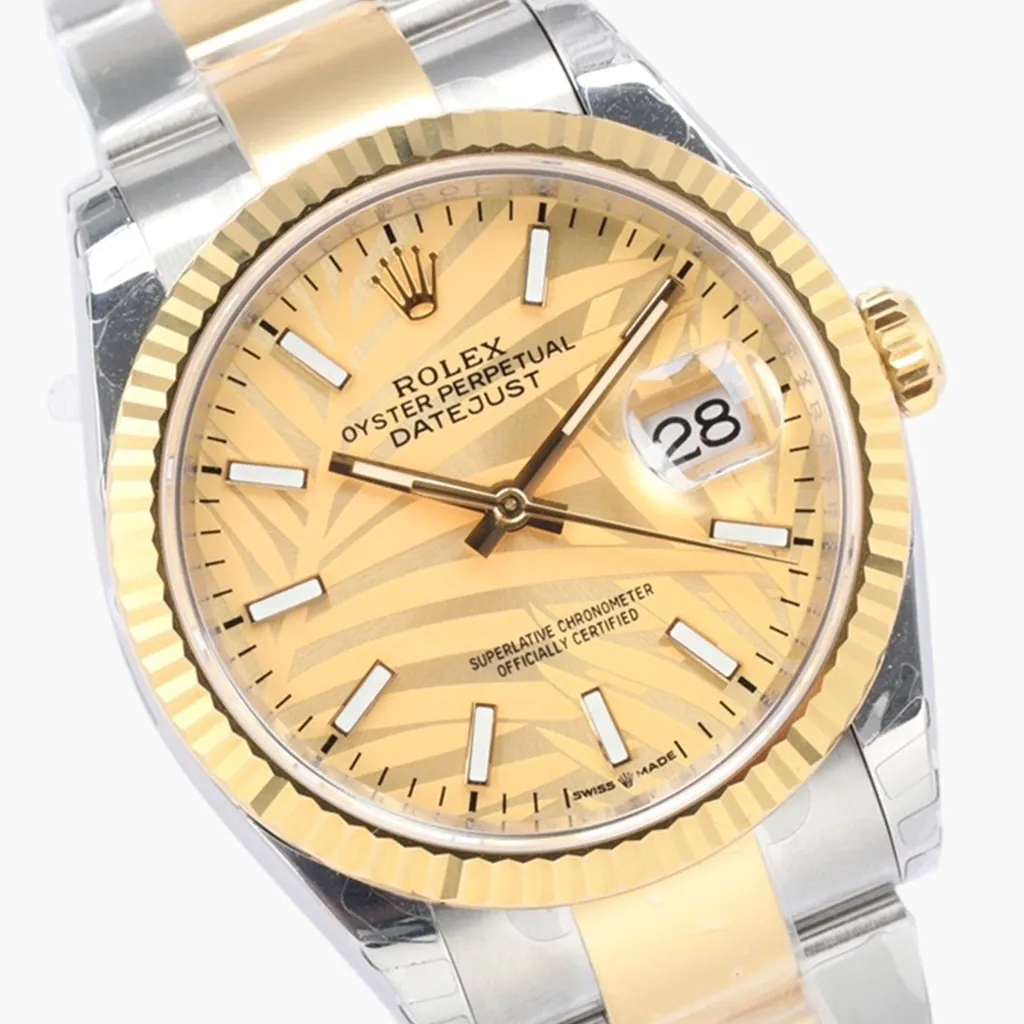 Rolex Datejust 36 126233 champagne palm motif dial watch with yellow gold fluted bezel, Cyclops date window, and two-tone Oyster bracelet.
