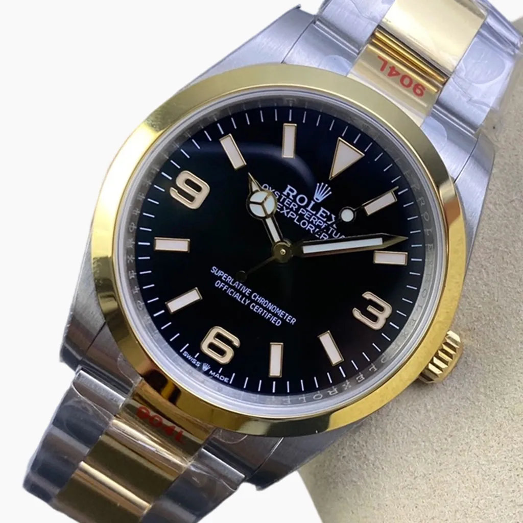 Rolex Explorer 124273 Oyster Perpetual black dial two-tone watch with gold bezel, stainless steel and yellow gold bracelet, and classic 3-6-9 hour markers.