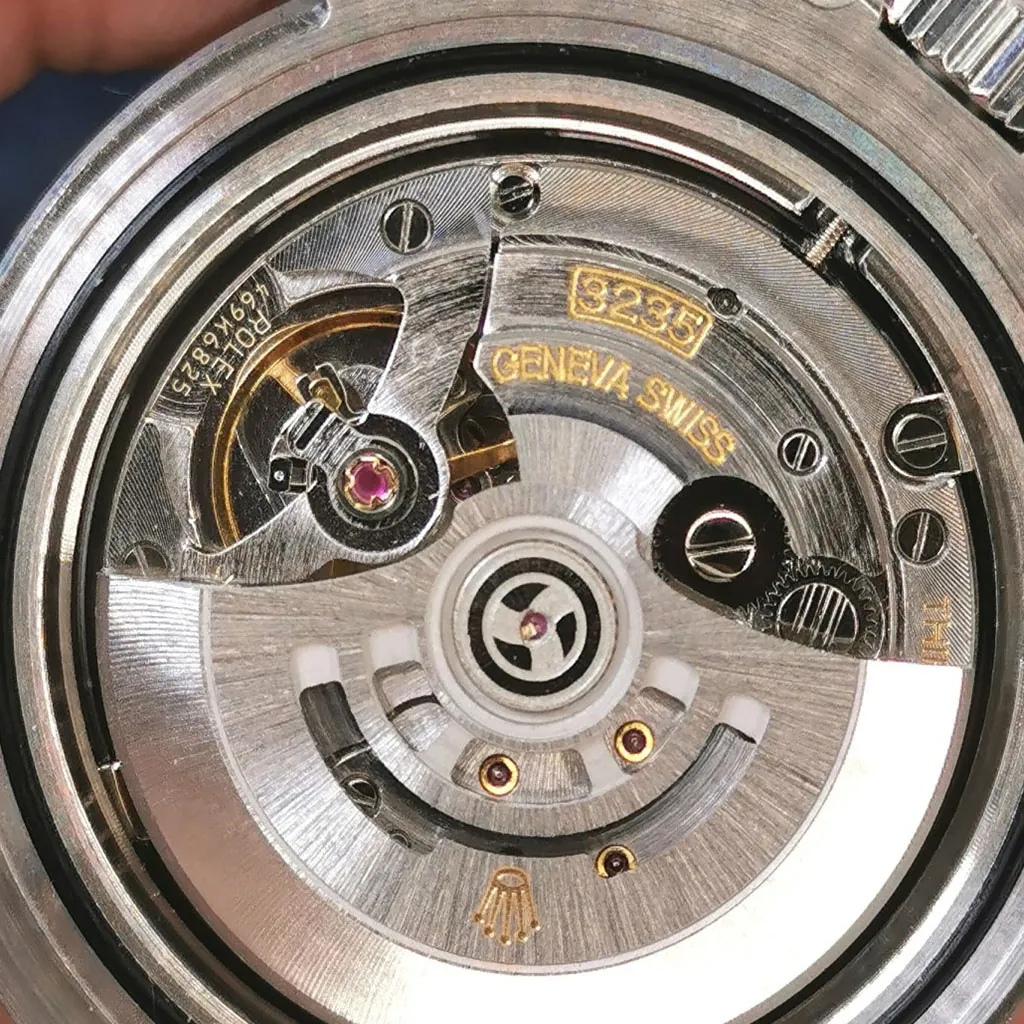 Rolex Caliber 3235 automatic movement close-up with Geneva Swiss engraving, rotor, jewel bearing and mechanical watch caseback details