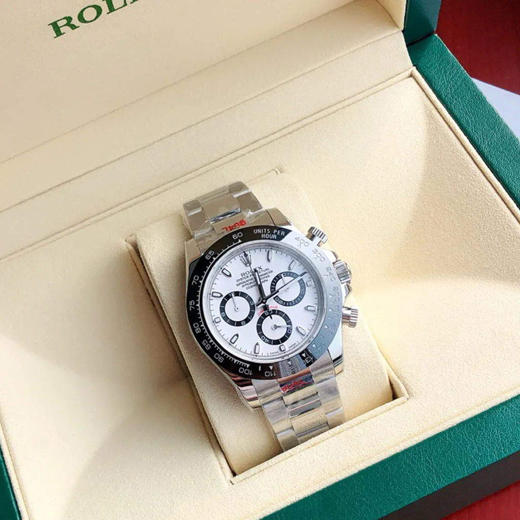 Rolex Cosmograph Daytona watch with white panda dial, black tachymeter bezel, chronograph subdials, Oyster bracelet and green Rolex box