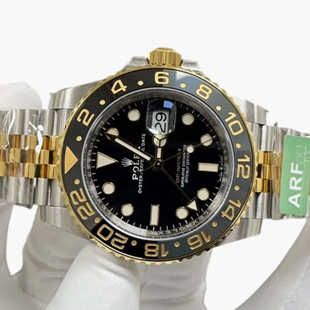 Rolex GMT-Master II two-tone watch with black dial, black 24-hour bezel, gold accents, Jubilee bracelet and magnified date window