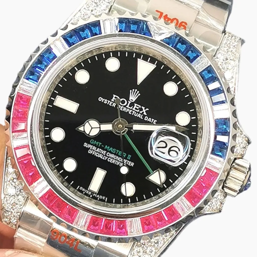 Rolex GMT-Master II Oyster Perpetual Date watch with black dial, green GMT hand, cyclops date window, red and blue gemstone Pepsi bezel, and diamond-set case.