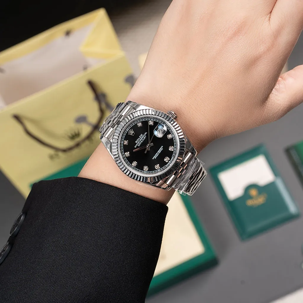 Rolex Oyster Perpetual Datejust black diamond dial watch with fluted bezel, Jubilee bracelet, and Rolex box accessories.