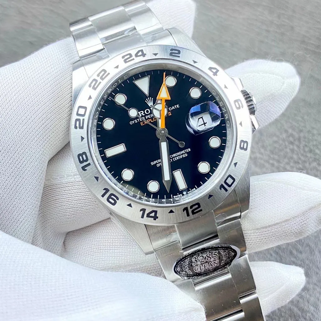Rolex Explorer II black dial watch with orange GMT hand, 24-hour bezel, Cyclops date window, and stainless steel Oyster bracelet