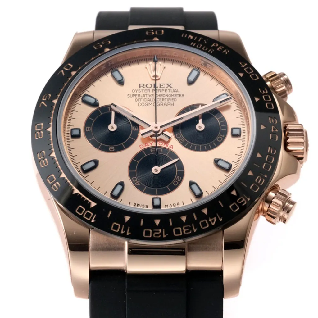 Rolex Cosmograph Daytona rose gold watch with champagne dial, black ceramic tachymeter bezel, chronograph subdials, and black Oysterflex rubber strap