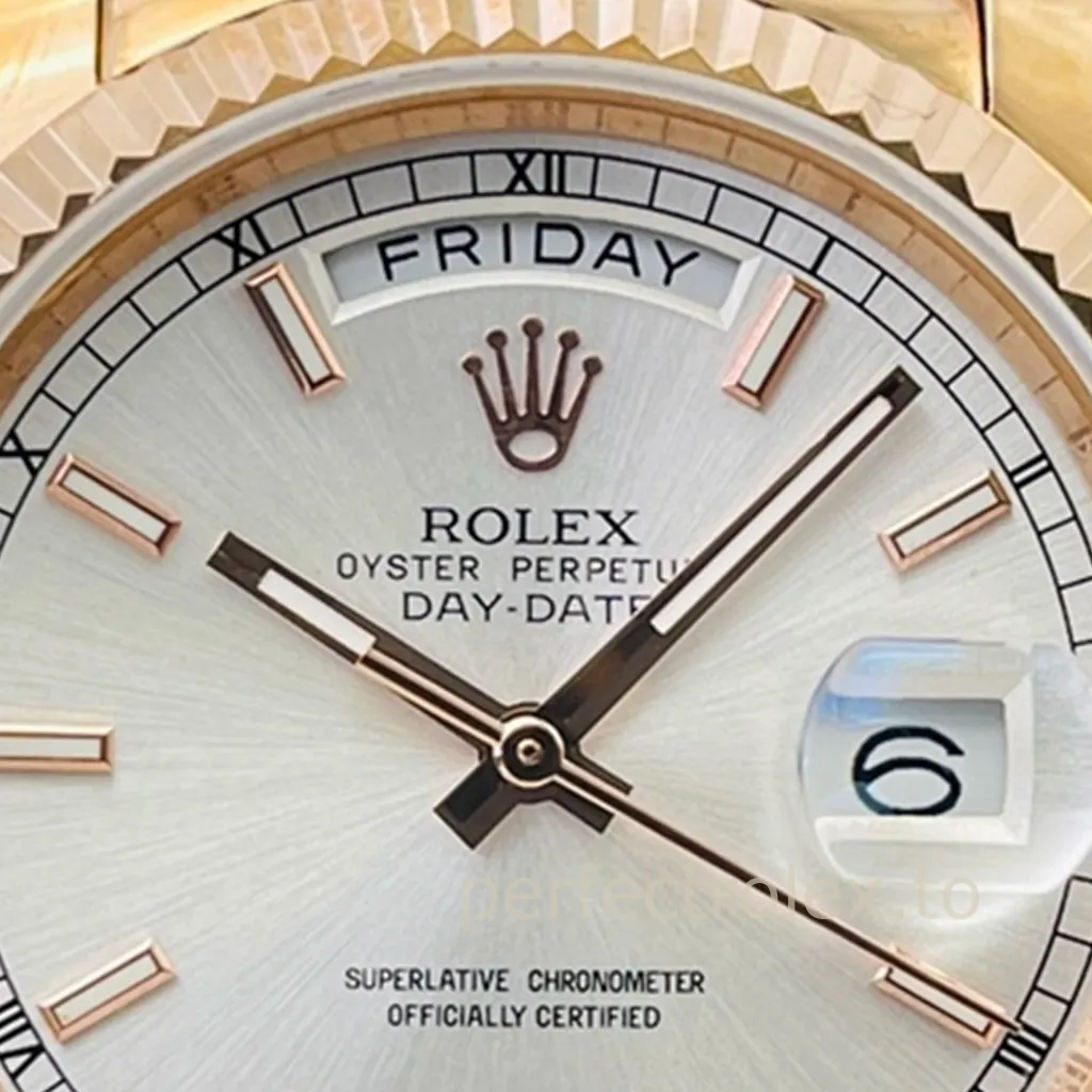 Rolex Oyster Perpetual Day-Date watch with gold fluted bezel, silver dial, day window, and magnified date display close-up