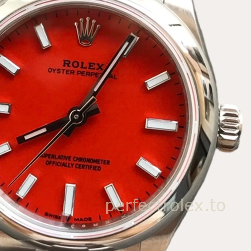 Rolex Oyster Perpetual watch with red dial, stainless steel case, baton hour markers, and three-hand display close-up