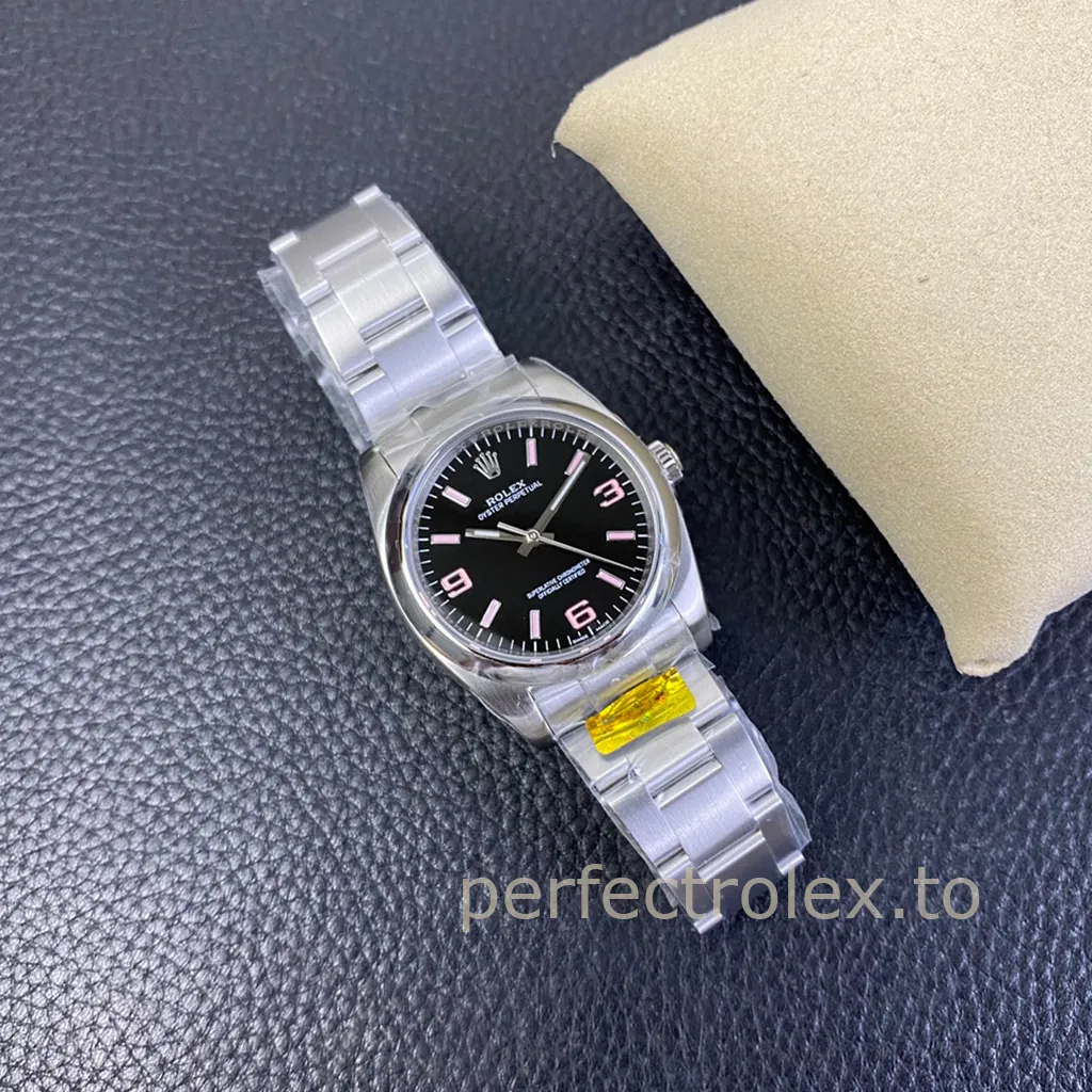 Rolex Oyster Perpetual 36 watch with black dial, pink 369 hour markers, stainless steel Oyster bracelet, and leather background close-up