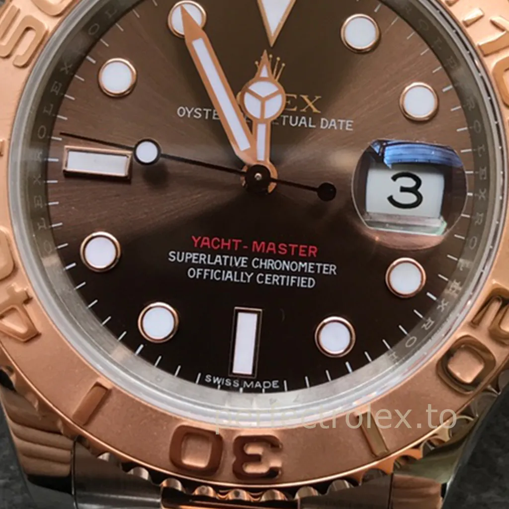 Rolex Yacht-Master watch with chocolate dial, rose gold bezel, magnified date window, Mercedes hands, and luminous hour markers close-up