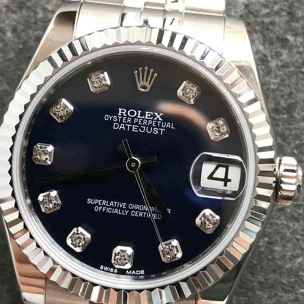 Rolex Oyster Perpetual Datejust black diamond dial watch with fluted bezel, Cyclops date window and stainless steel bracelet close-up