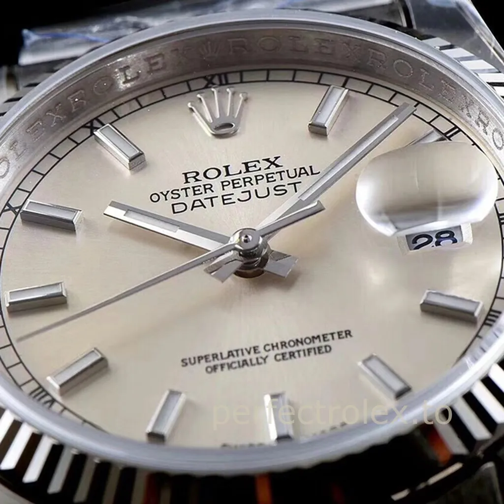 Rolex Datejust silver dial close-up with fluted bezel, baton hour markers, and Cyclops date window.