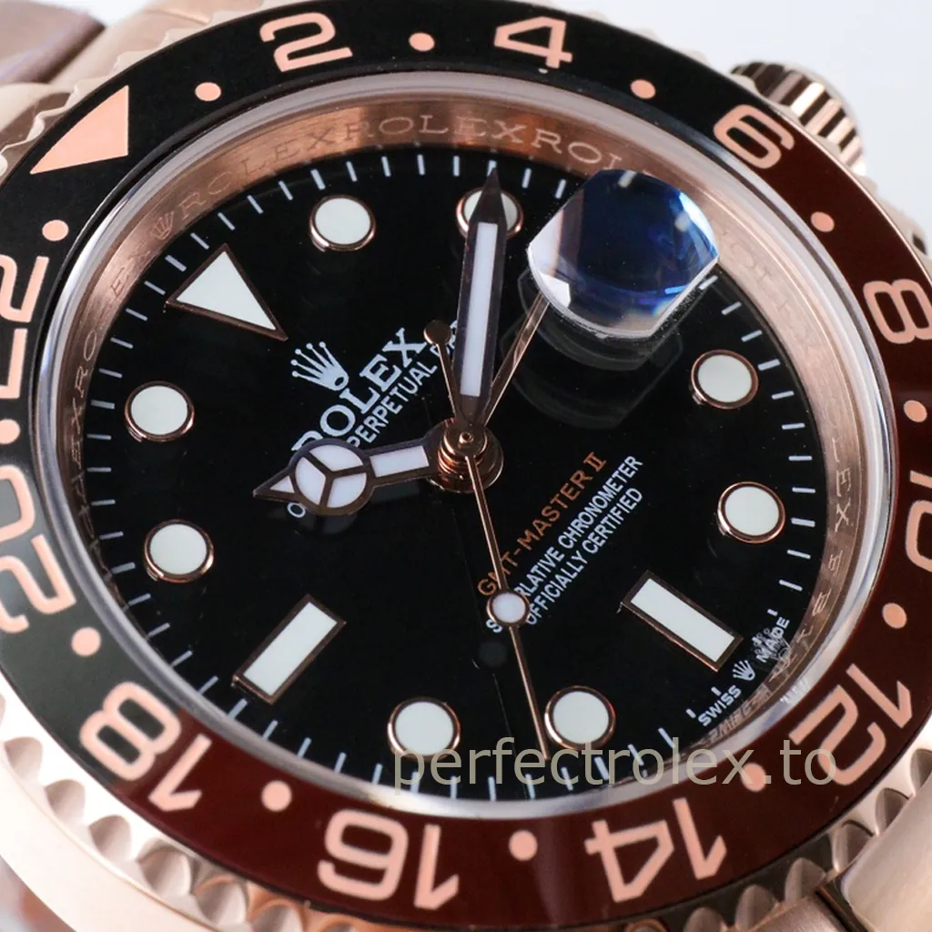 Rolex GMT-Master II black dial close-up with brown ceramic bezel, luminous markers, Mercedes hands, and Cyclops date lens.
