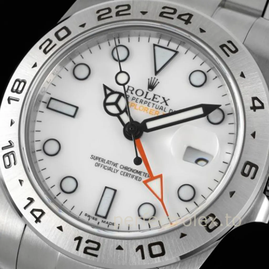 Rolex Oyster Perpetual Explorer II Polar with a white dial, orange 24-hour GMT hand, luminous markers, date magnifier, and brushed steel bezel.