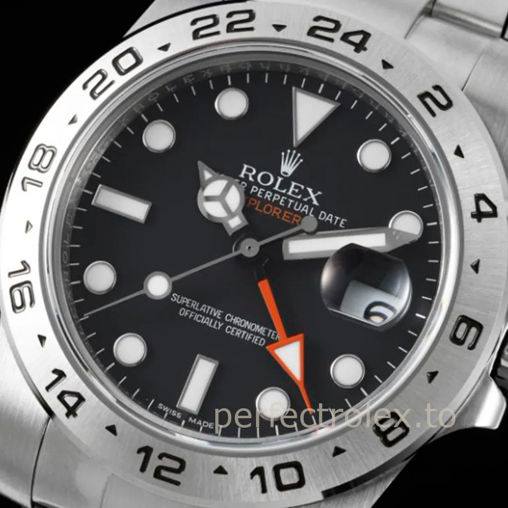 Rolex Oyster Perpetual Explorer II with a black dial, orange 24-hour GMT hand, date magnifier, luminous markers, and brushed steel bezel.