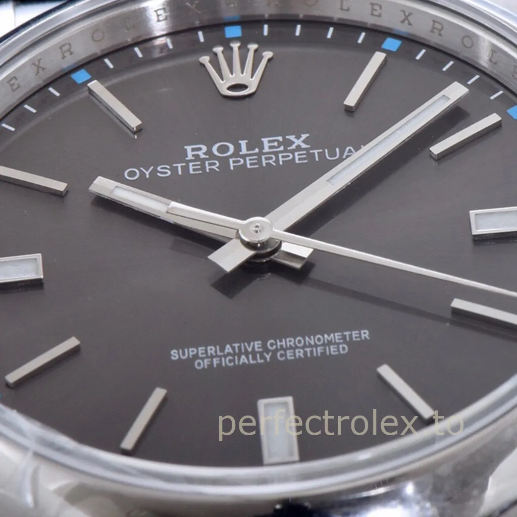 Rolex Oyster Perpetual watch with a dark grey dial, silver baton markers, luminous hands, and blue minute accents.