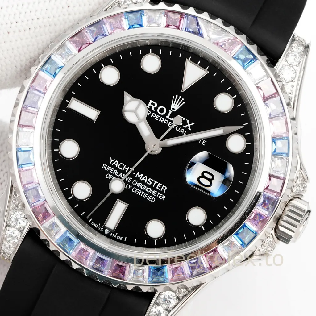 Rolex Yacht-Master watch with a black dial, multicolor baguette gemstone bezel, diamond-set lugs, date window, silver-tone case, and black rubber strap.