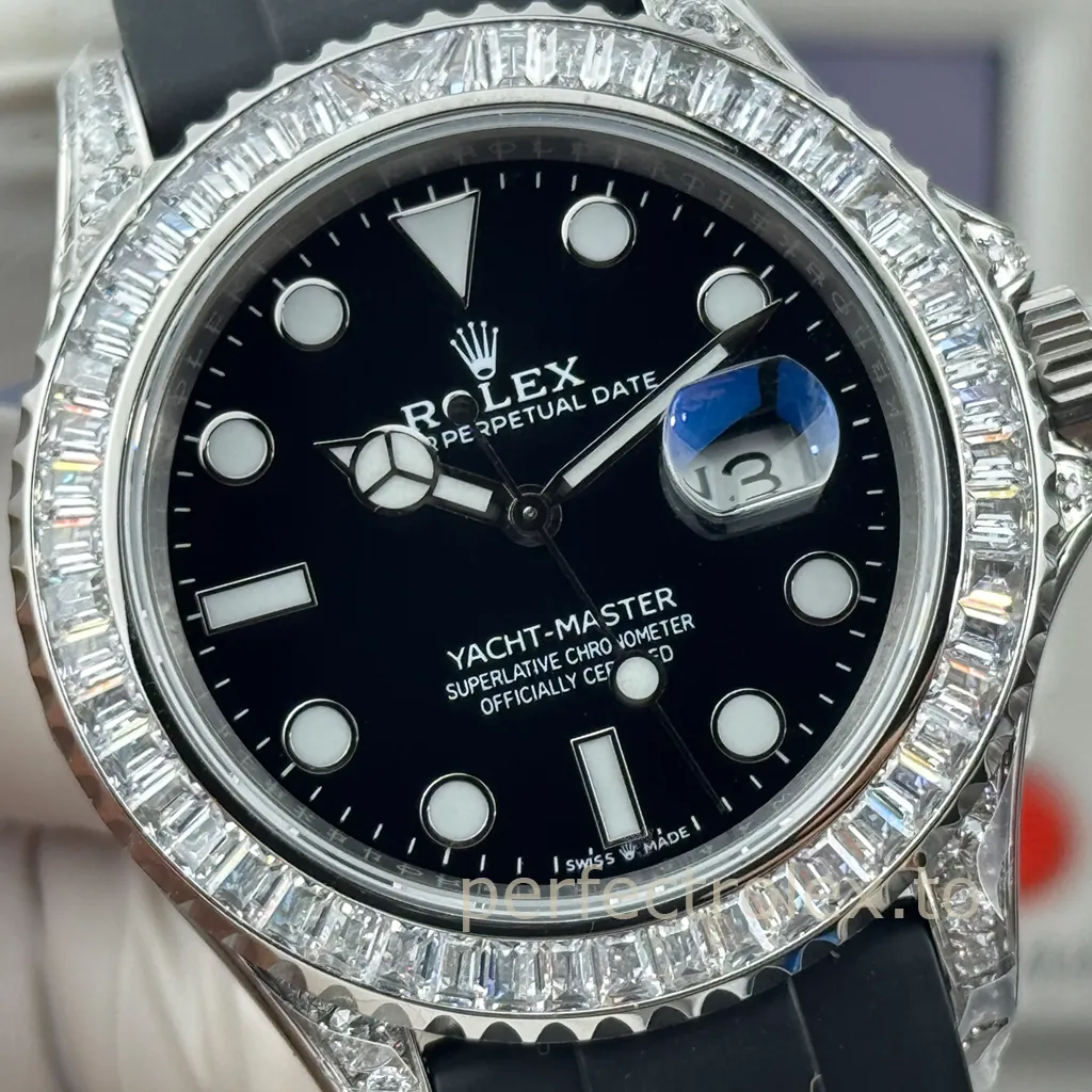 Rolex Yacht-Master watch with a black dial, baguette diamond bezel, diamond-set lugs, date window, silver-tone case, and black rubber strap.