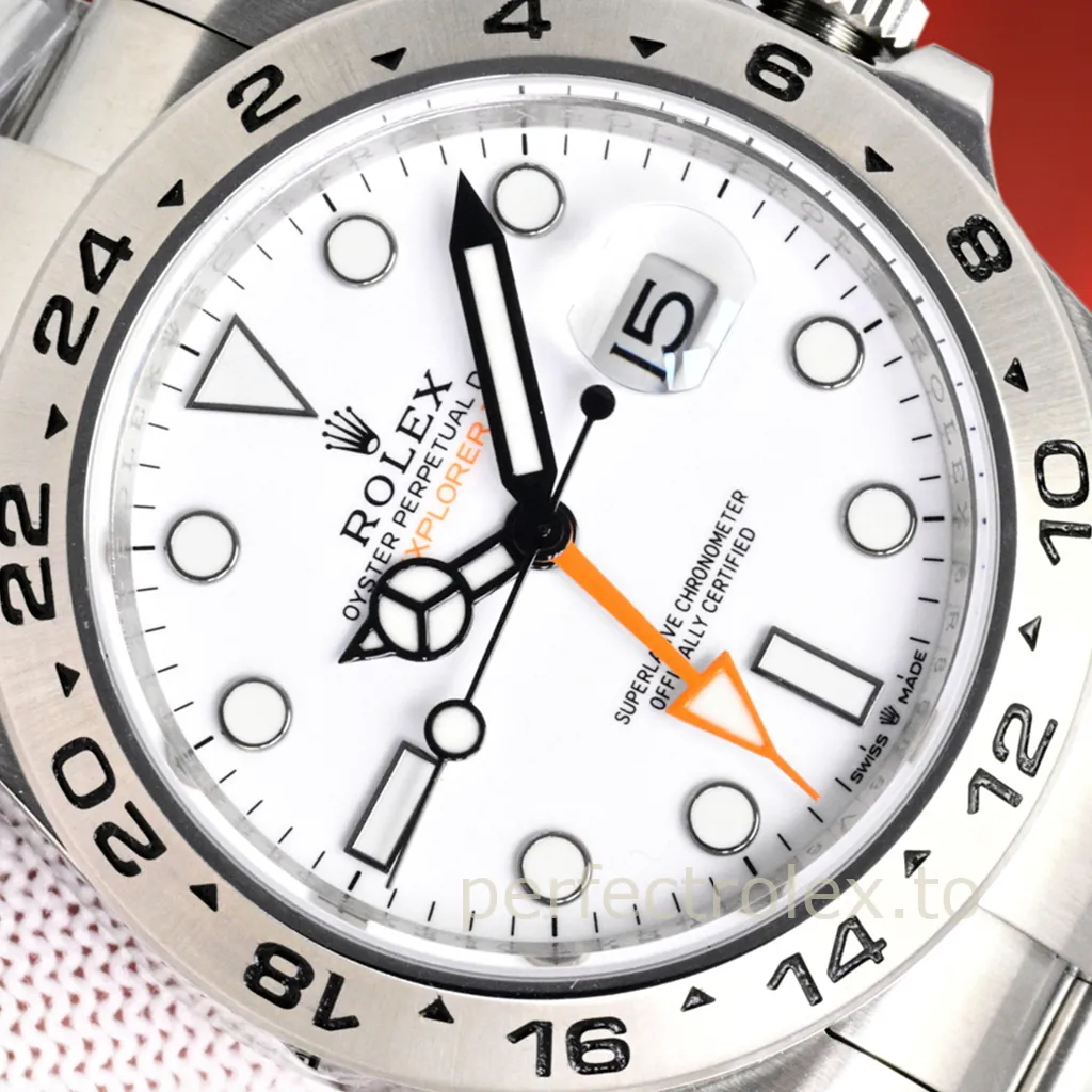 Rolex Oyster Perpetual Explorer II Date with white Polar dial, stainless steel 24-hour bezel, luminous markers, orange GMT hand, and Cyclops date window.