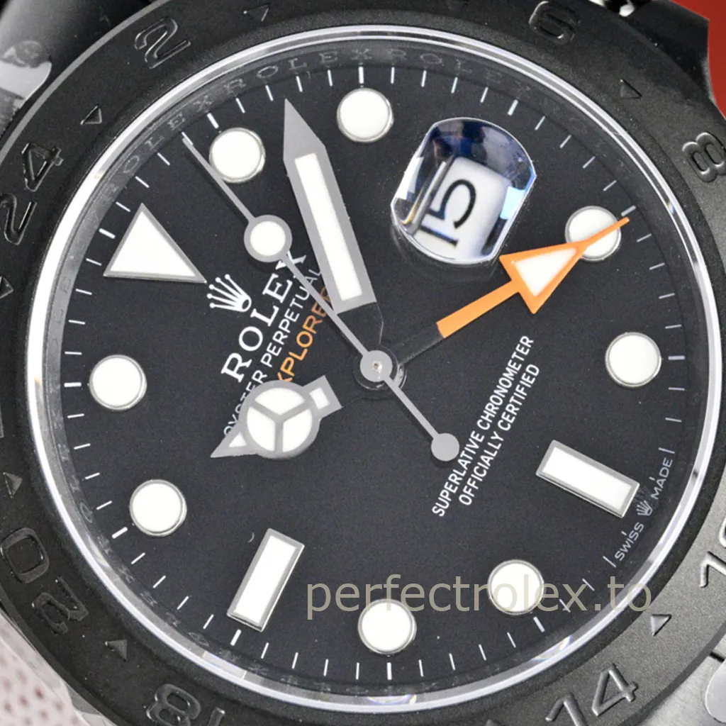 Rolex Oyster Perpetual Explorer II Date with black dial, black 24-hour bezel, luminous markers, orange GMT hand, and Cyclops date window.