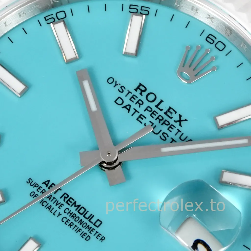 Close-up of an AET Remould Rolex Datejust featuring a turquoise dial, luminous hour markers, silver hands, and Cyclops date window.
