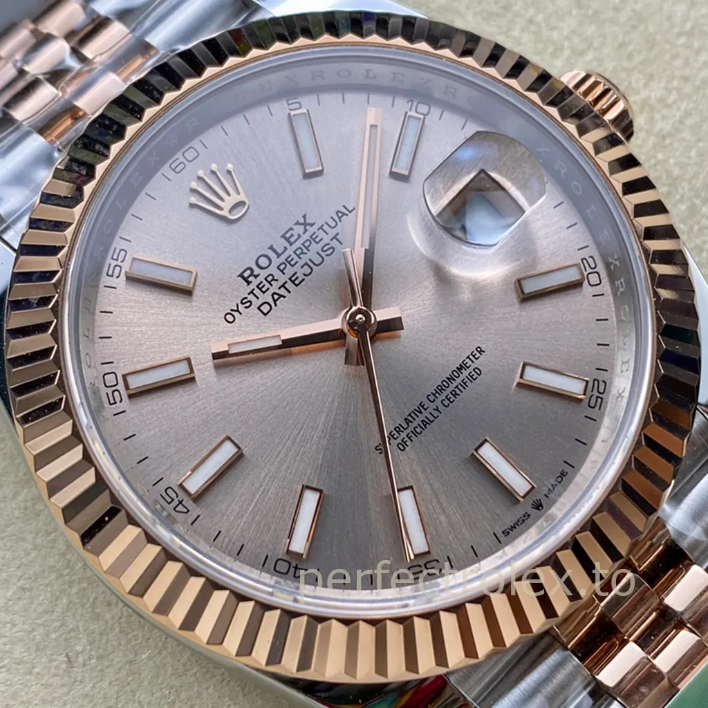 Rolex Datejust two-tone watch with a silver sunburst dial, Everose gold fluted bezel, luminous baton markers, Cyclops date window, and Jubilee bracelet.